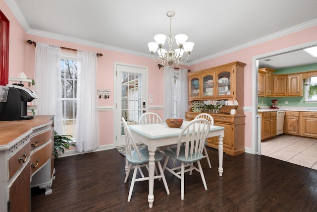 dining room featuring hardwood / wood-style floors, ornamental molding, and a chandelier