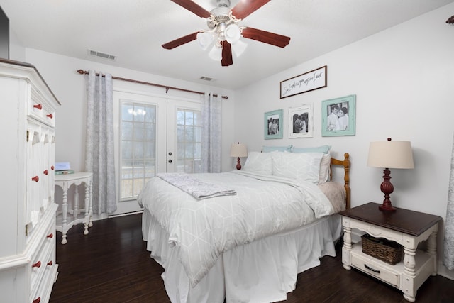 bedroom with multiple windows, dark hardwood / wood-style floors, access to outside, and french doors