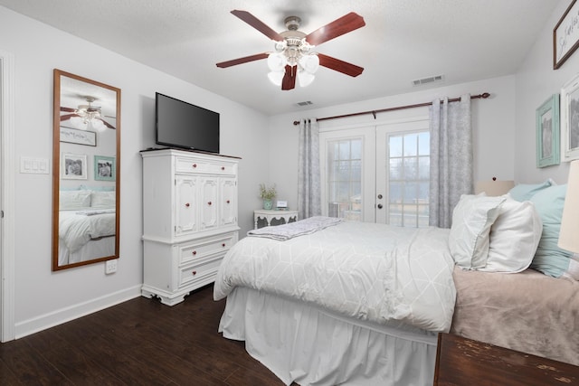 bedroom with dark hardwood / wood-style floors, ceiling fan, and french doors