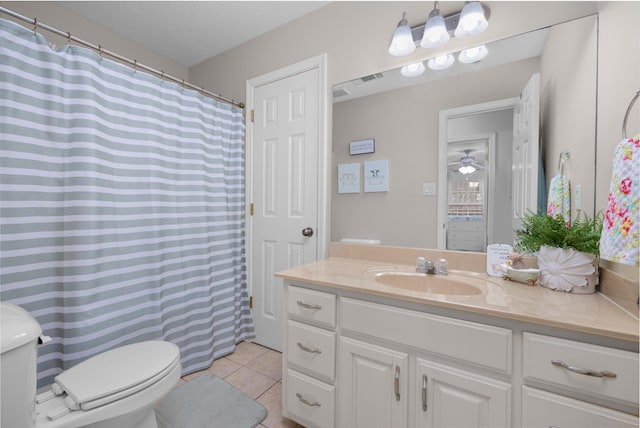 bathroom featuring tile patterned floors, toilet, vanity, and a textured ceiling