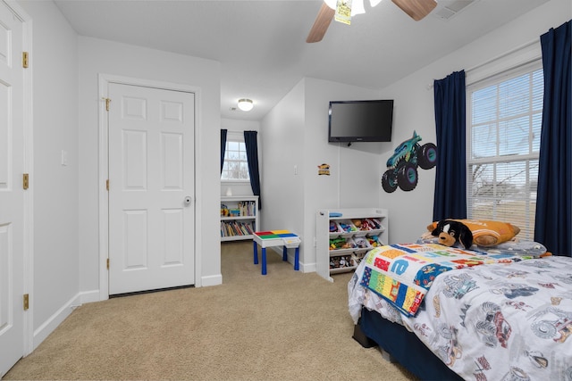 bedroom featuring ceiling fan and carpet