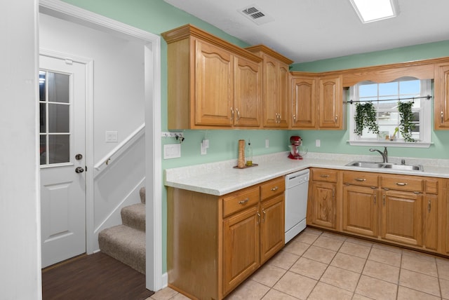 kitchen with sink, light tile patterned floors, and white dishwasher