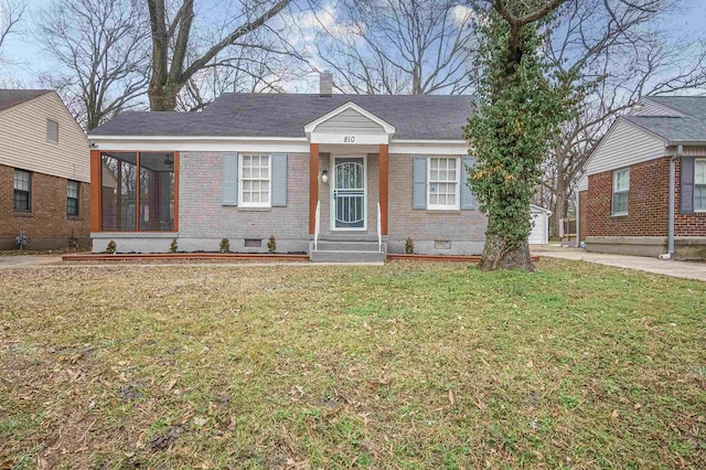 view of front of property with a front lawn and a sunroom