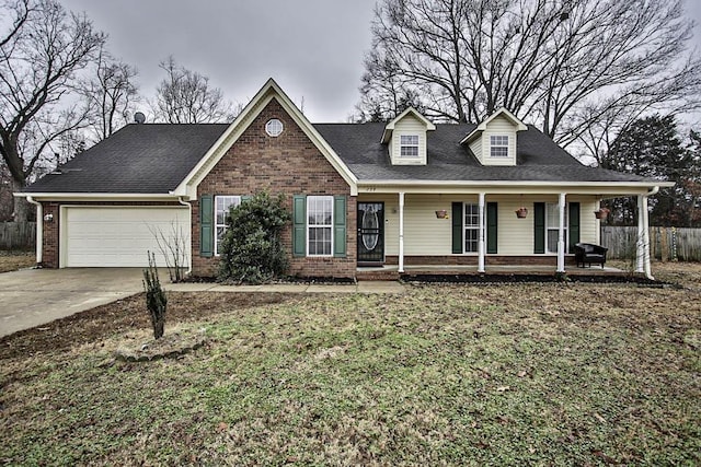 view of front of house featuring a garage, a porch, and a front lawn