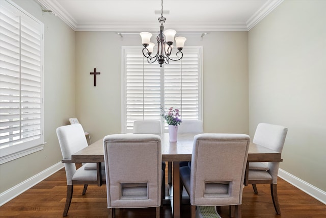 dining room featuring ornamental molding, dark wood-type flooring, and an inviting chandelier