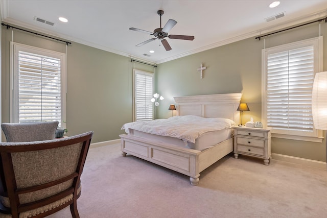 carpeted bedroom featuring crown molding and ceiling fan