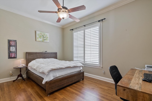 bedroom featuring multiple windows, hardwood / wood-style floors, and ornamental molding