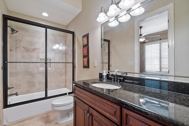 full bathroom with ceiling fan, combined bath / shower with glass door, vanity, tile patterned floors, and toilet