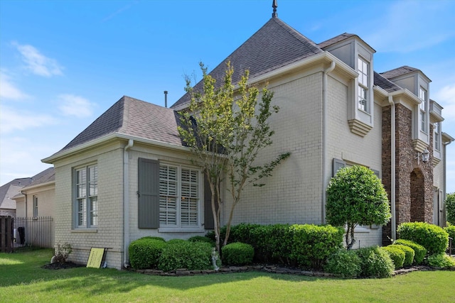 view of side of property with a lawn