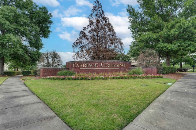 community / neighborhood sign with a lawn