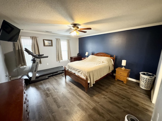 unfurnished bedroom with dark wood-type flooring, ceiling fan, ornamental molding, and a textured ceiling