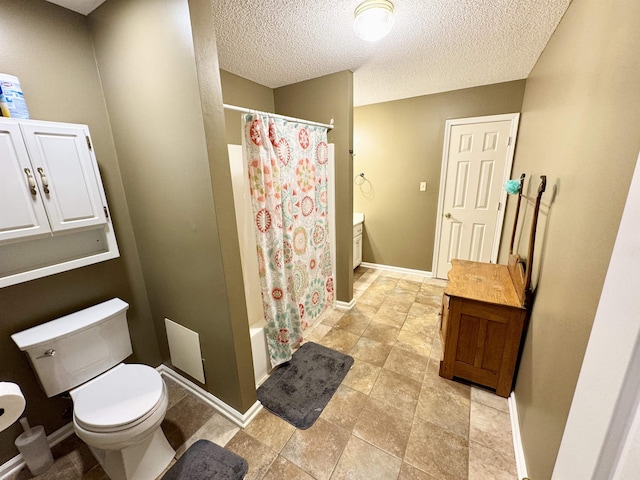 full bathroom with vanity, toilet, a textured ceiling, and shower / bath combo