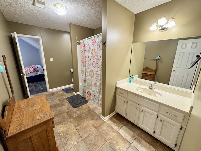 bathroom featuring vanity and a textured ceiling