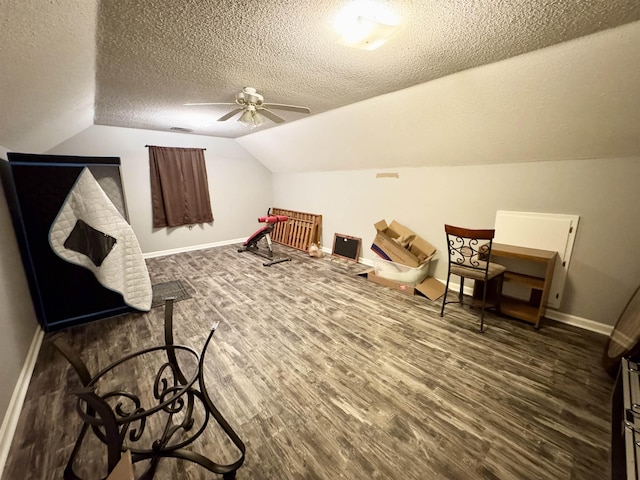 bedroom featuring dark hardwood / wood-style flooring, ceiling fan, lofted ceiling, and a textured ceiling