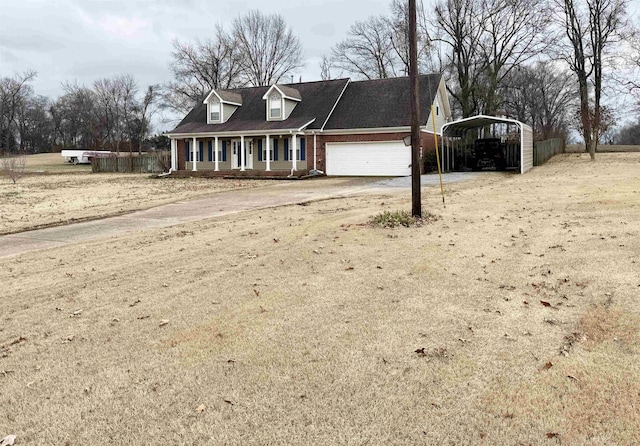 view of front of property featuring a carport, a garage, and covered porch