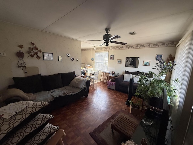 living room with ceiling fan and dark parquet floors