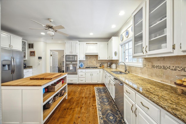 kitchen featuring white cabinetry, stainless steel appliances, sink, and butcher block countertops