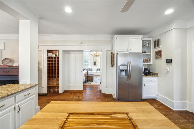 kitchen with white cabinetry, stainless steel fridge with ice dispenser, and ornamental molding