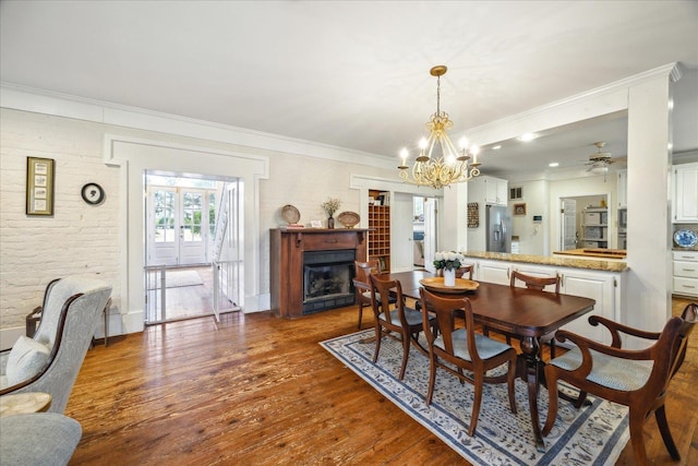 dining space with ornamental molding and dark hardwood / wood-style floors