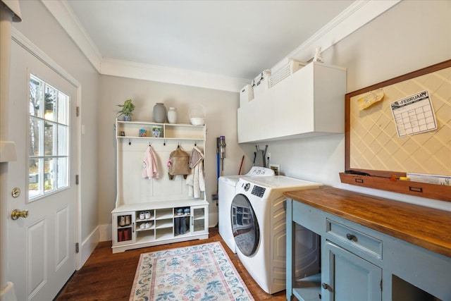 laundry area with independent washer and dryer, dark hardwood / wood-style floors, ornamental molding, and cabinets