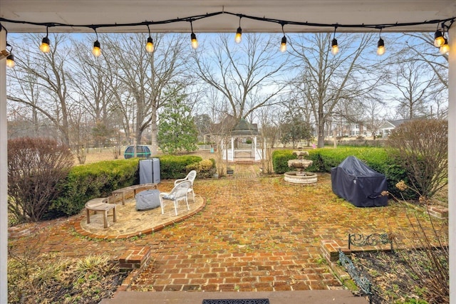 view of yard featuring a gazebo and a patio area