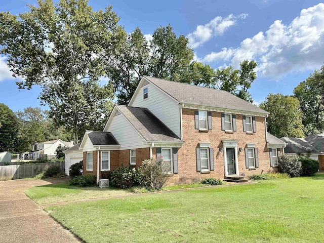 colonial-style house featuring a front yard