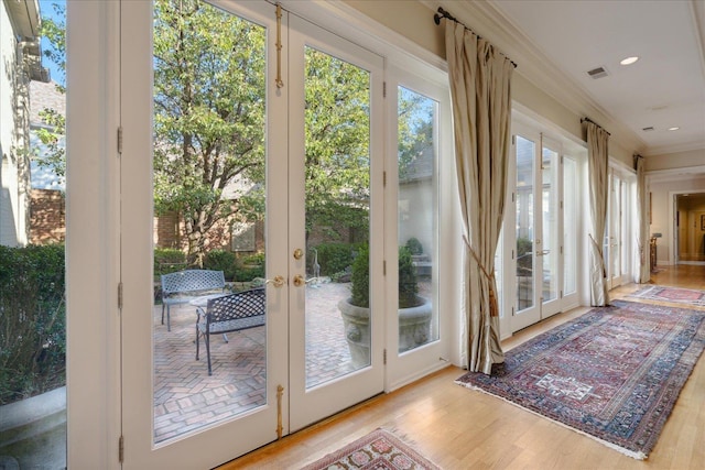 entryway featuring light hardwood / wood-style flooring and ornamental molding