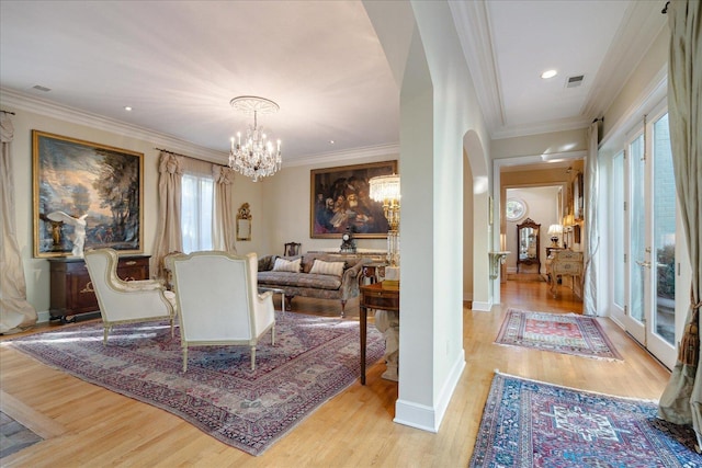 dining room with crown molding, a chandelier, and light wood-type flooring