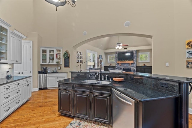 kitchen with sink, a center island with sink, dishwasher, ceiling fan, and white cabinets