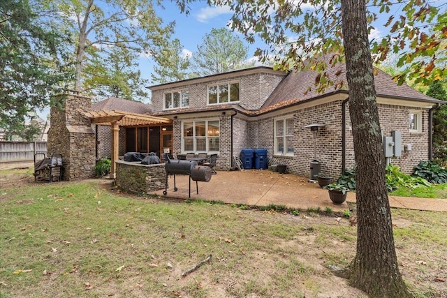 back of property featuring a pergola, a lawn, and a patio area