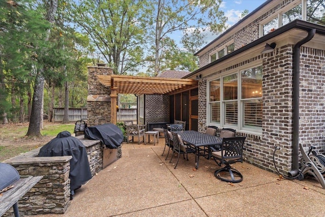 view of patio featuring grilling area and a pergola