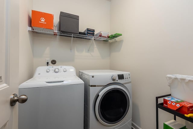 clothes washing area with washer and dryer