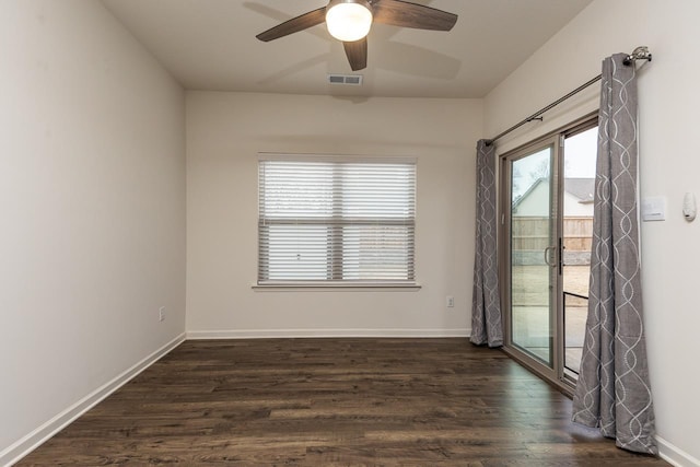 spare room with dark wood-type flooring and ceiling fan