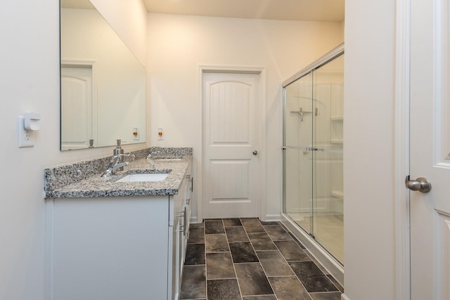 bathroom featuring vanity and an enclosed shower