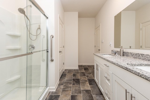 bathroom featuring vanity and a shower with door