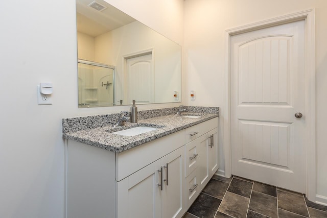 bathroom featuring vanity and an enclosed shower