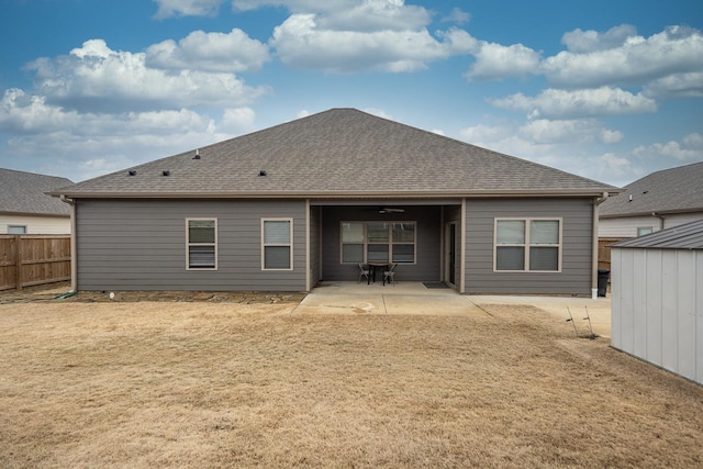 back of property featuring a patio area and a lawn