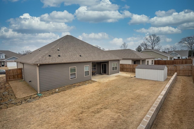 rear view of property featuring a patio area and a storage shed