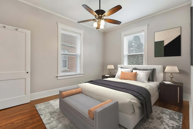 bedroom featuring ceiling fan, ornamental molding, and dark hardwood / wood-style floors