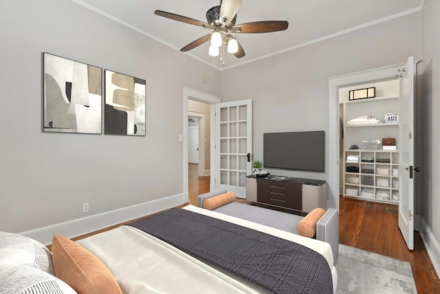 bedroom with crown molding, ceiling fan, and dark hardwood / wood-style flooring