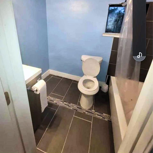 bathroom featuring tile patterned floors and toilet