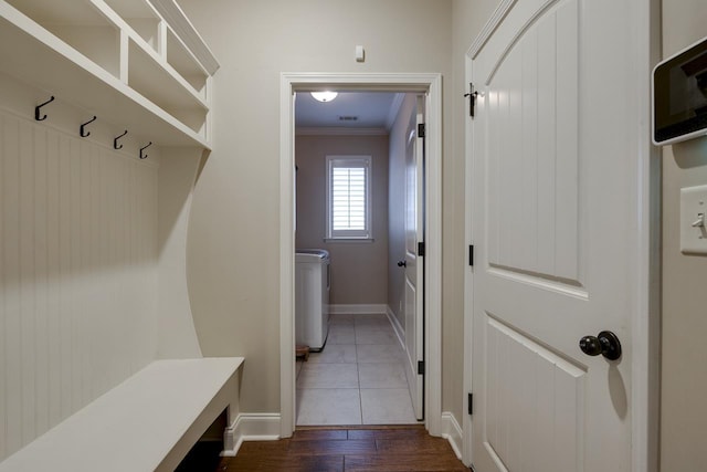 mudroom featuring crown molding and dark wood-type flooring