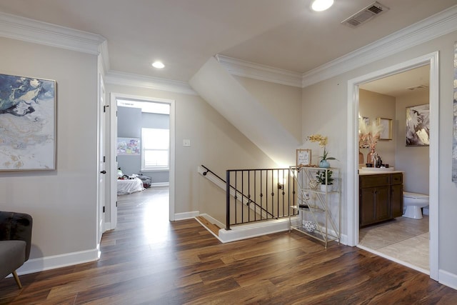 corridor featuring crown molding and dark hardwood / wood-style flooring