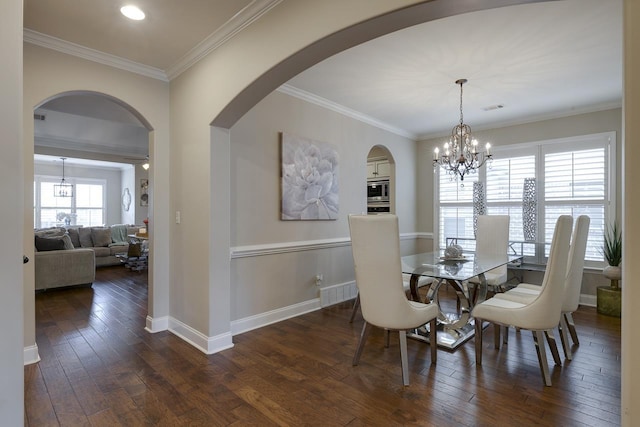 dining room featuring a notable chandelier, crown molding, and dark hardwood / wood-style floors