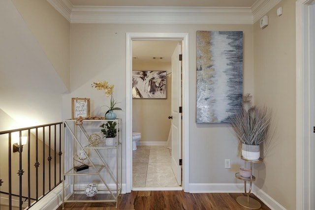 corridor featuring ornamental molding and wood-type flooring