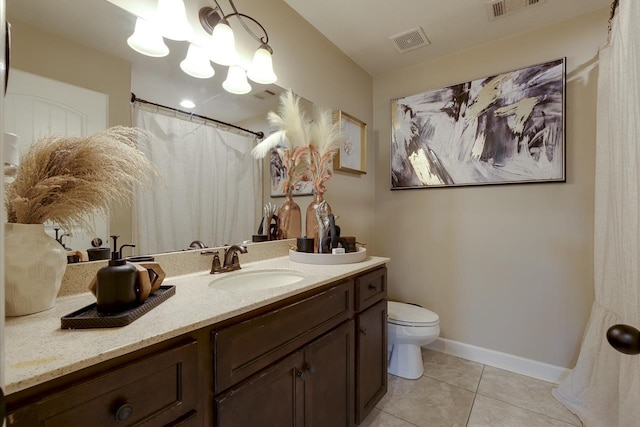 bathroom with vanity, tile patterned floors, and toilet