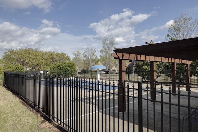 view of gate with a community pool and a pergola