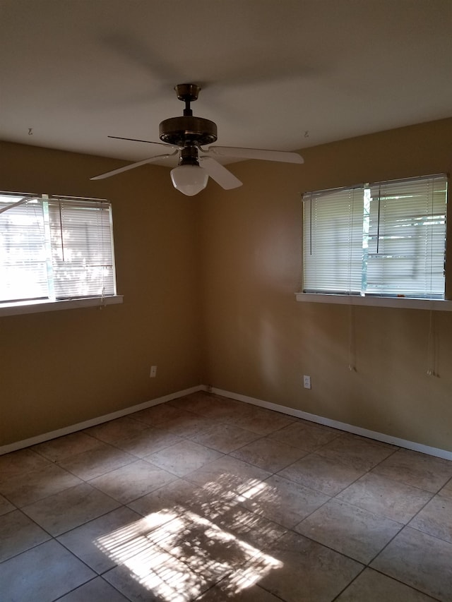 unfurnished room featuring ceiling fan and light tile patterned floors