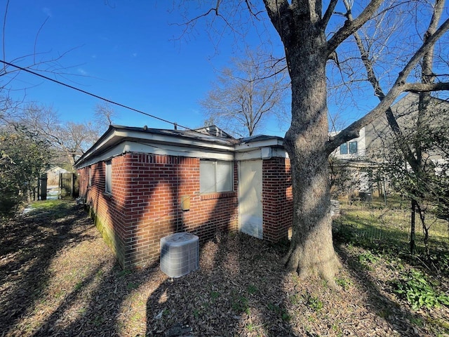 view of side of home with central AC unit