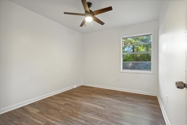 unfurnished room with dark hardwood / wood-style floors and ceiling fan